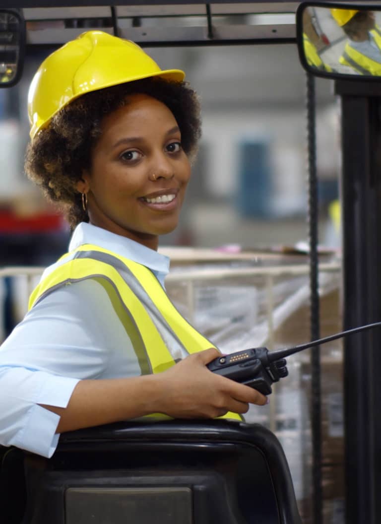 Female forklift driver working in warehouse
