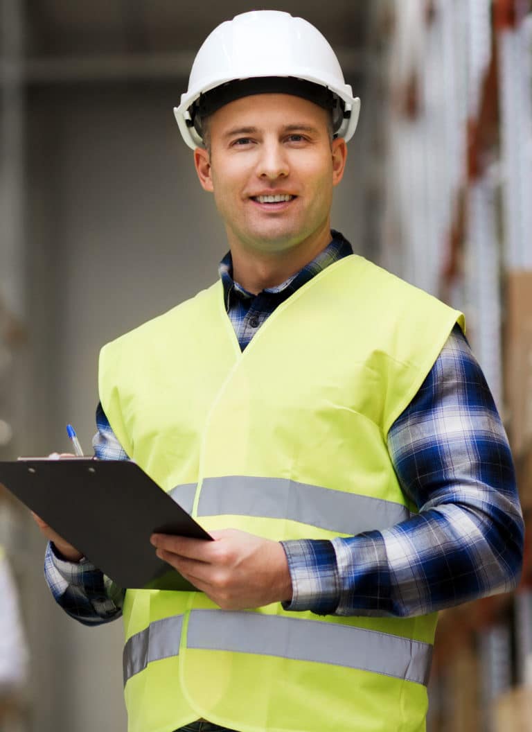 Man with clipboard in safety vest at warehouse
